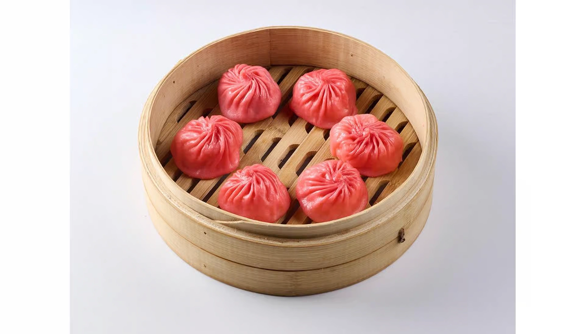 Chicken xiaolongbao with orange wrapper