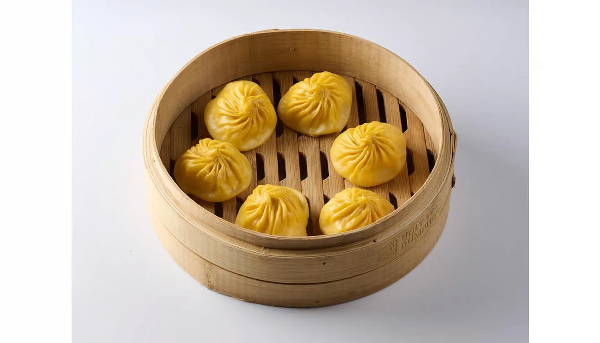 Pork and crab soup dumplings on bamboo steamer