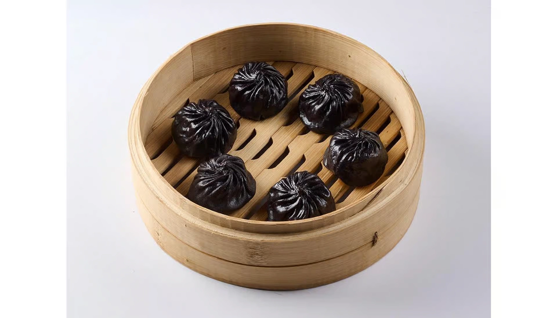 Pork & Truffle Soup Dumplings — black-pleated xiaolongbao